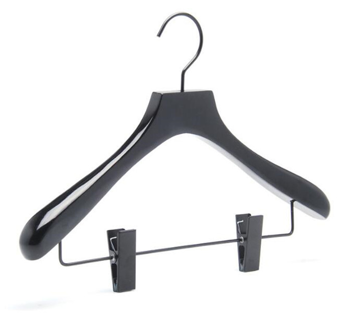 shiny black painting  on wooden coat rack with metal clips
