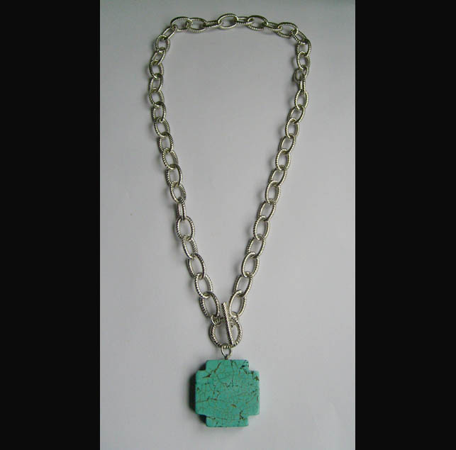 Necklace is made of chain and turq stone.