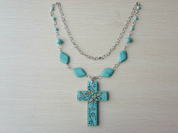 Necklace is made of stone and cross stone with enamel.