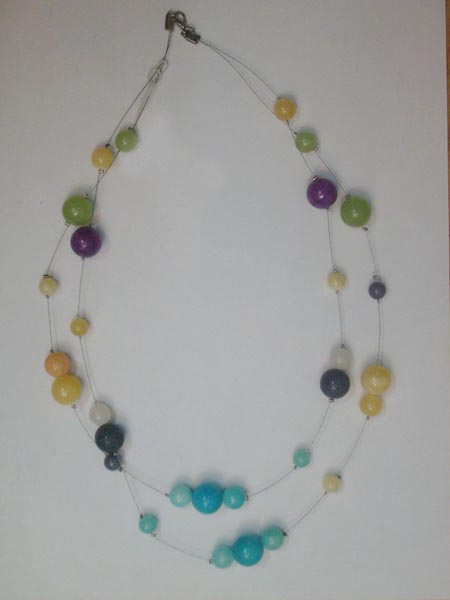 Necklace is made of semi-precious stone.